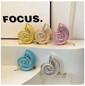 Five metallic conch-shaped chain bags in yellow, gold, pink, blue, and silver on white display