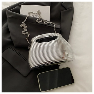 Detailed view of silver ripple textured acrylic clutch bag with metal chain strap and phone