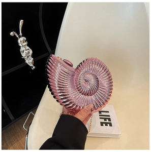 Pink shell-shaped clutch bag featuring a metallic finish and elegant gold chain strap