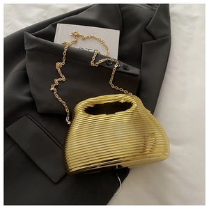 Detail of gold hard shell evening clutch with wave ripples and detachable chain strap