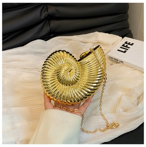 Detailed view of golden conch clutch bag with spiral texture and elegant chain strap