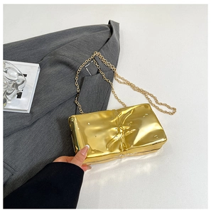 Detail showing the gold chain strap and crinkled texture of this stylish acrylic box bag