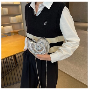 Detailed view of a silver nautilus shell clutch bag with metallic texture and chain strap