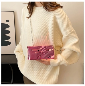 Detail of rose pink metallic acrylic bag with crinkle texture and silver chain strap