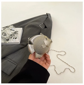 Detailed view of silver metallic fish-shaped mini bag with textured scales and chain strap
