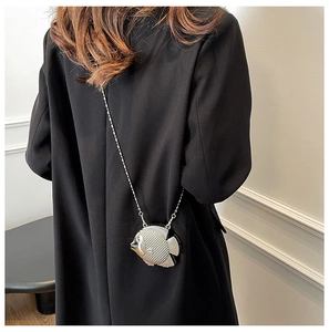 Detailed view of fish-shaped silver mini bag with rhinestone texture and metal chain