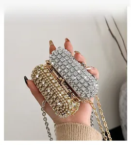 Detail of shimmering gold and silver rhinestone evening bags with metal chain straps