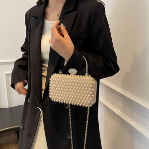 Elegant pearl evening clutch with sparkling diamond clasp and gold chain strap for women