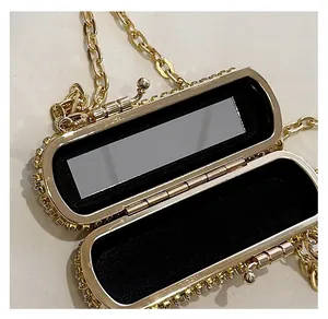 Detail view of mini rhinestone clutch with built-in mirror and soft velvet lining