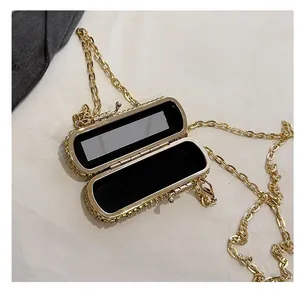Detail view of mini gold evening bag with built-in mirror and velvet lining