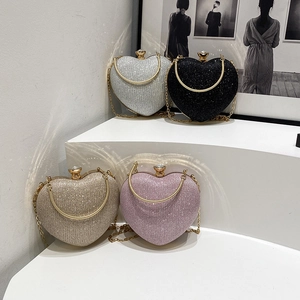Sparkling heart-shaped evening clutch bag with glitter finish and elegant chain strap