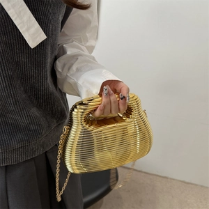 Golden acrylic handbag with horizontal wavy texture and elegant metal chain strap