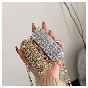 Detail of mini rhinestone evening bags in gold and silver with elegant chain straps