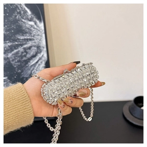Close-up of sparkling silver rhinestone evening clutch bag with metal chain strap