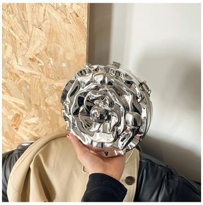 Detailed macro of a silver rose flower shaped metal clutch bag with 3D petals