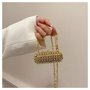 Macro detail of luxury gold rhinestone evening bag with elegant metal chain strap