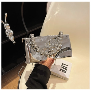Dettaglio mini borsa argento a specchio con manico in perle metalliche e tracolla