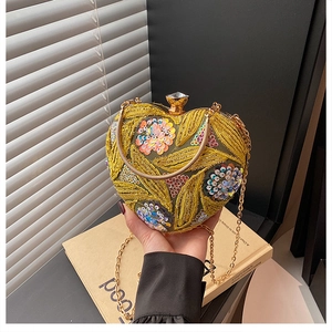 Detailed embroidery and iridescent sequins on a heart-shaped luxury evening bag