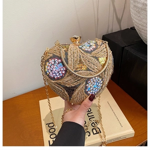 Macro shot of heart-shaped evening bag with golden embroidery and colorful sequins