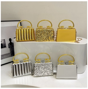 Detailed view of acrylic clutch bags with dragon handles and metallic textures