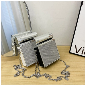 Close-up of luxury rhinestone-studded box bags with silver chain and metal clasp