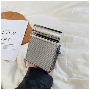 Macro detail of camera-shaped crossbody bag featuring sparkling silver rhinestones