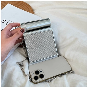 Detail of square silver rhinestone clutch bag with metal handle and thick chain strap