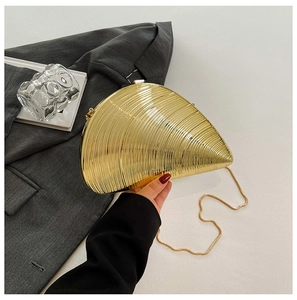 Golden shell-shaped evening clutch with spiral texture and elegant chain strap detail