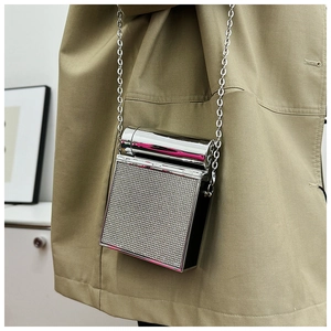 Close-up of sparkling silver rhinestone evening clutch with fine metal chain strap