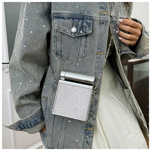 Silver square crossbody bag with rhinestones and metal chain strap on model