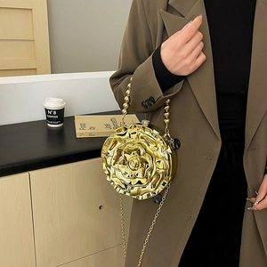 Golden rose shape acrylic evening bag with beaded handle and chain strap on model