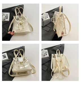 Detail view of transparent PVC backpack with cream inner pouch and gold hardware