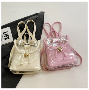 Detail view of mini jelly backpacks in cream and pink with PVC layers and metal locks