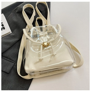 Detail of transparent PVC backpack with beige inner pouch and gold twist-lock closure
