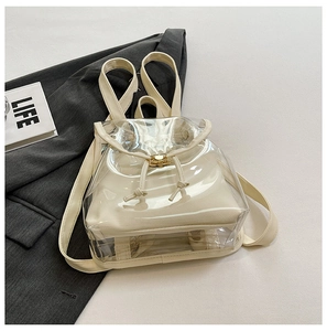 Detail of transparent PVC backpack with beige canvas lining and golden metal drawstring lock