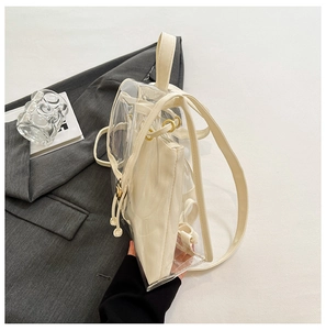 Detailed view of clear PVC backpack with beige canvas inner pouch and drawstring closure