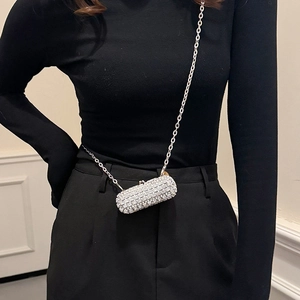 Sparkling rhinestone cylinder evening bag with silver chain worn by a model