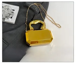 Gold mirror acrylic box clutch bag shown next to a smartphone for size comparison