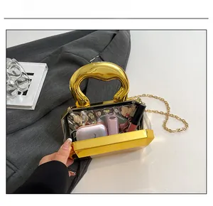 Macro view of transparent acrylic box bag interior showing capacity for cosmetics
