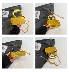 Detailed views of gold octagonal mirror clutch bag with chunky handle and fine chain strap