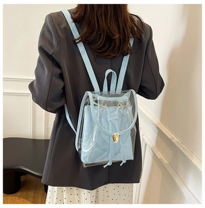 Detail of light blue transparent PVC backpack with drawstring closure and gold buckle