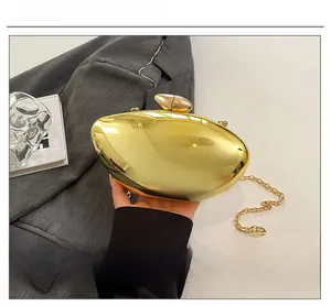 Detailed view of a gold metallic acrylic mango evening bag with mirror finish and chain strap