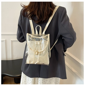 Transparent PVC backpack featuring white leather trim and a canvas drawstring inner pouch