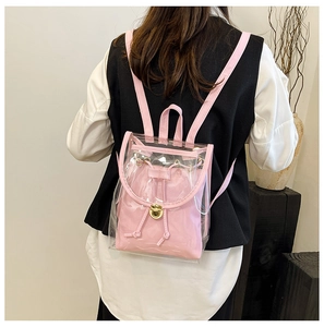 Rear view of a pink transparent PVC backpack with inner pouch on a female model