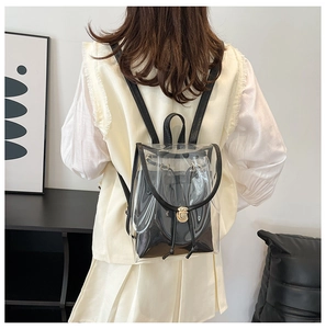 Model wearing a clear PVC backpack with a black leather inner pouch and gold lock