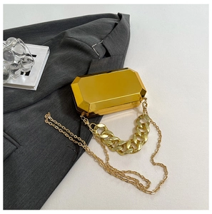 Detail of golden octagonal mirrored clutch bag with dual chunky and fine chains
