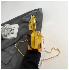 Macro shot of geometric gold rabbit ear clutch bag with chunky metal chain strap