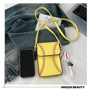Detailed view of yellow baseball-themed crossbody phone bag with strap and charms