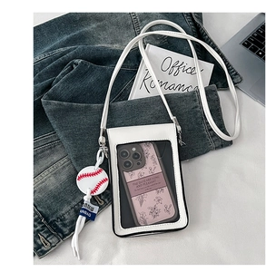 Detail of white PU leather crossbody phone bag with transparent window and baseball charm