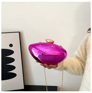 Detail of fuchsia acrylic mango evening bag with gold pebble clasp and fine chain strap